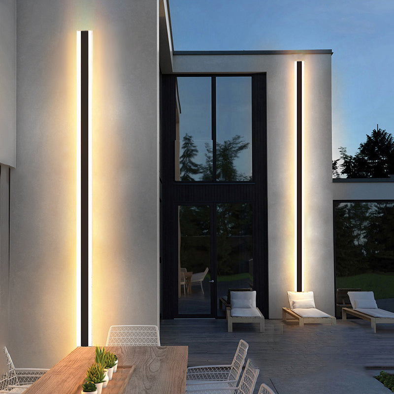 Luminaire extérieur applique murale LED bande longue aluminium présenté sur une façade extérieur